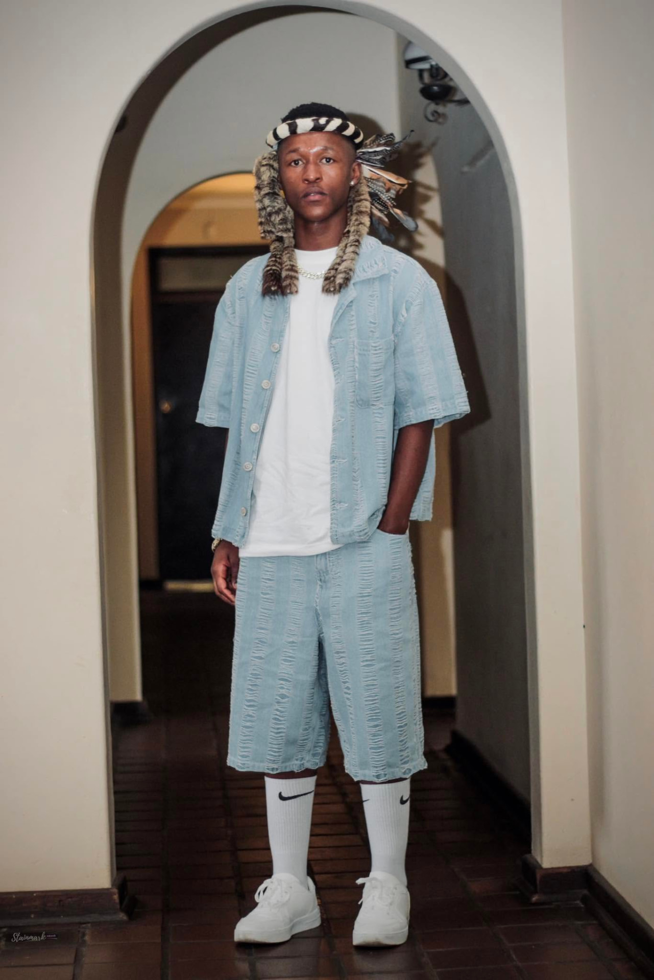 Sqiniseko SqinQ, South African Afro-pop artist, in denim and traditional Zulu headwear